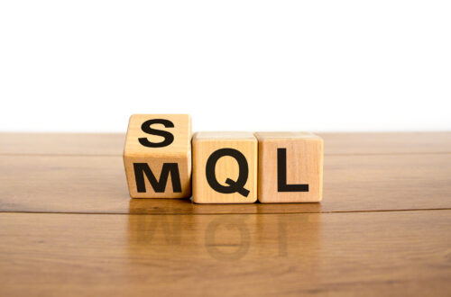 SQL or MQL symbol. Turned wooden cubes and changed words 'MQL marketing qualified lead' to 'SQL sales qualified lead'. Beautiful white background. Business and SQL or MQL concept. Copy space.