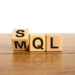 SQL or MQL symbol. Turned wooden cubes and changed words 'MQL marketing qualified lead' to 'SQL sales qualified lead'. Beautiful white background. Business and SQL or MQL concept. Copy space.